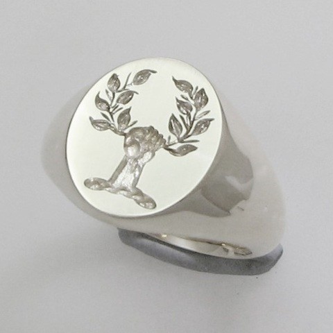 hand holding wreath crest ring